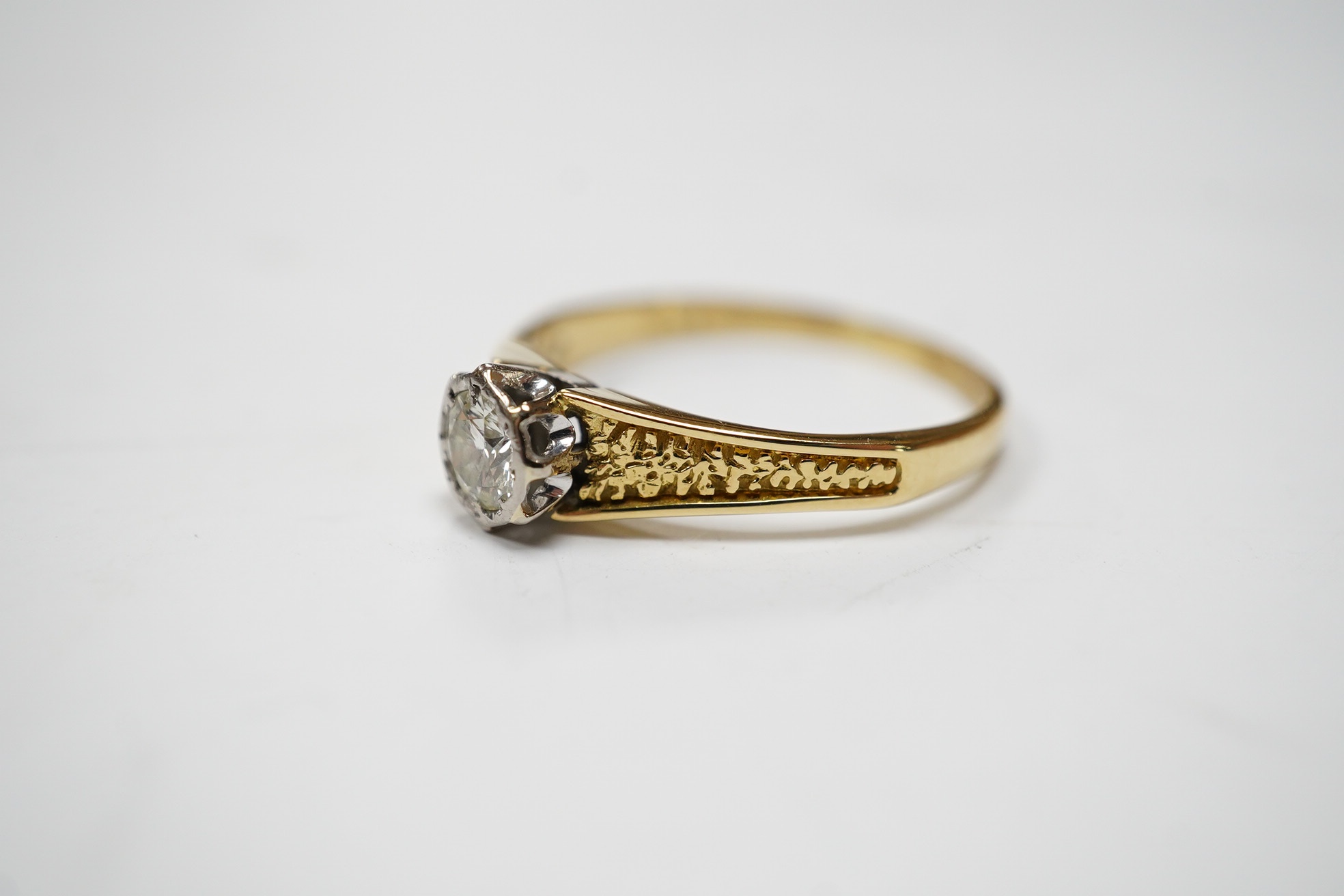 A yellow metal and illusion set solitaire diamond ring, size O/P, gross weight 2.7 grams. Condition - fair